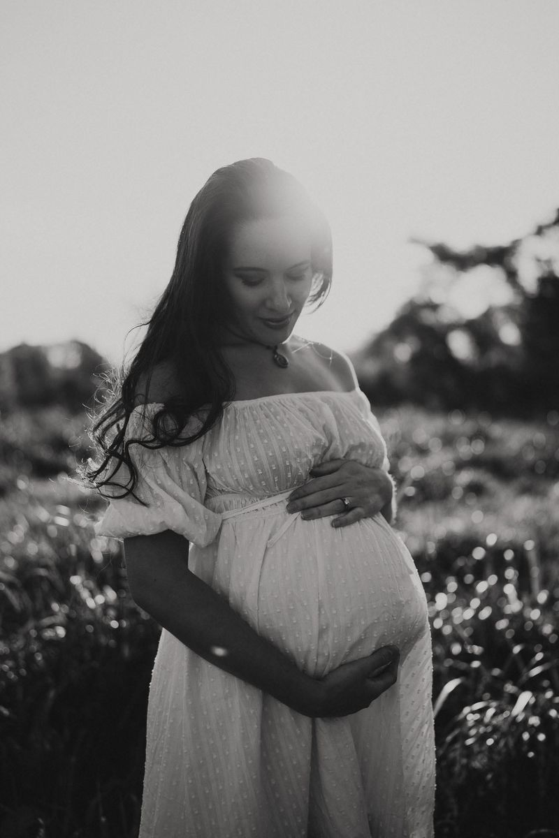 Black and white maternity portrait in soft evening light