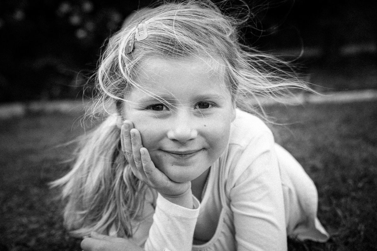 A young girl resting her chin on her hands