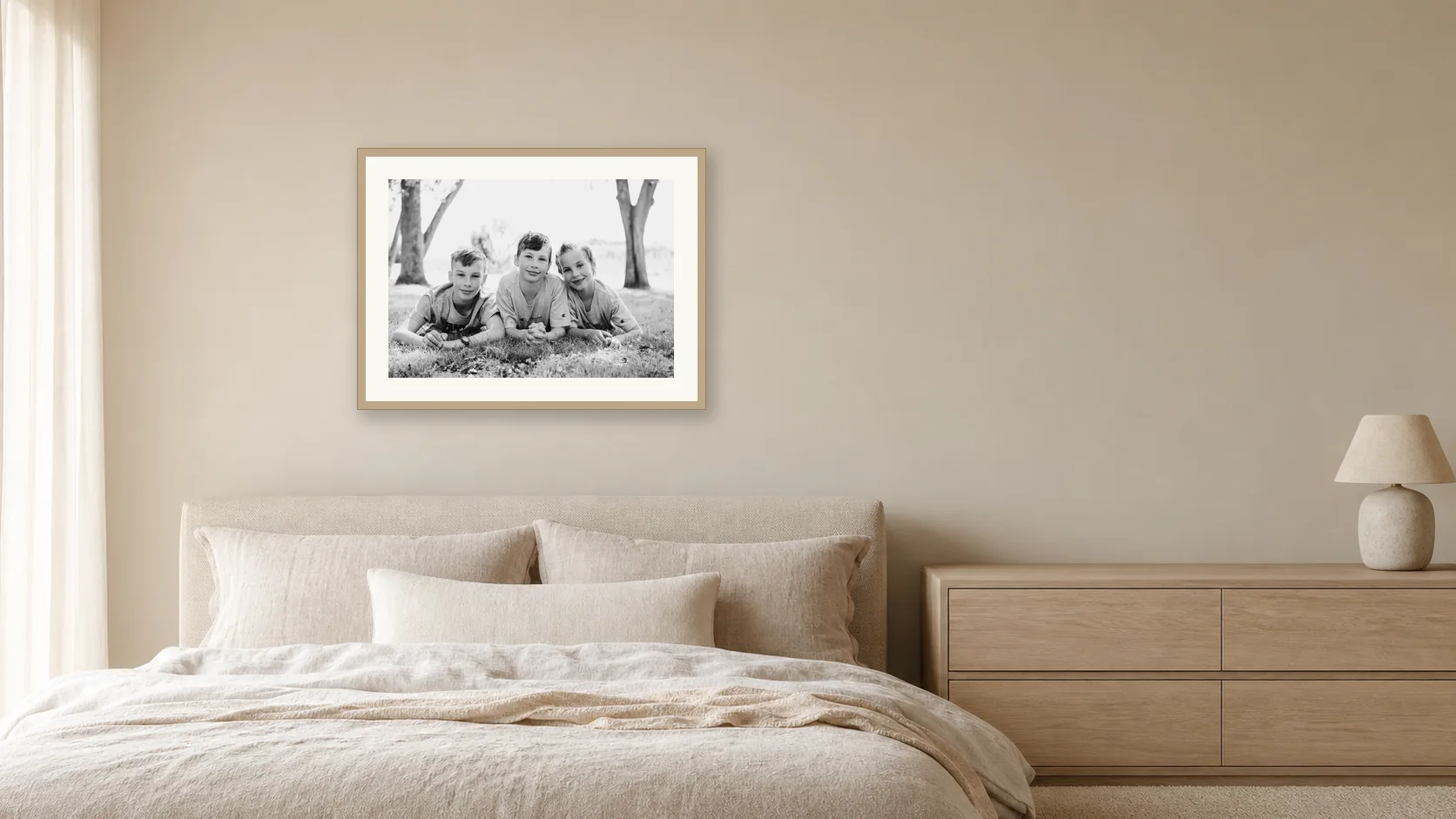 A black and white portrait of three boys above a bed