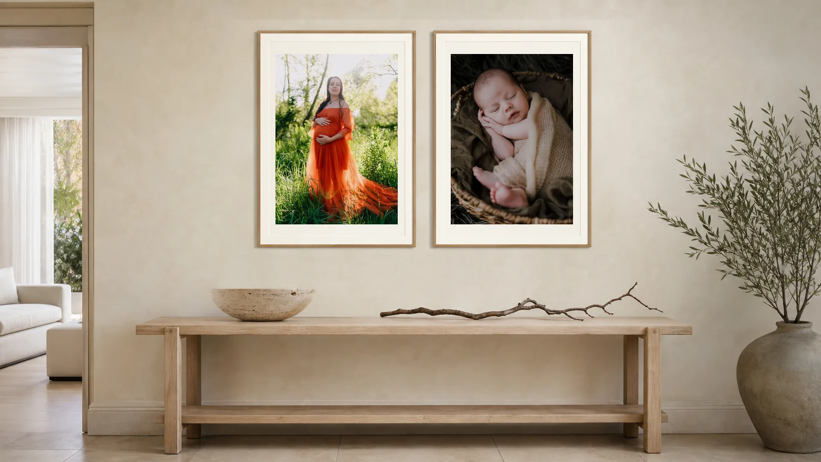 A maternity portrait and a newborn portrait as a matched pair above a hallway console