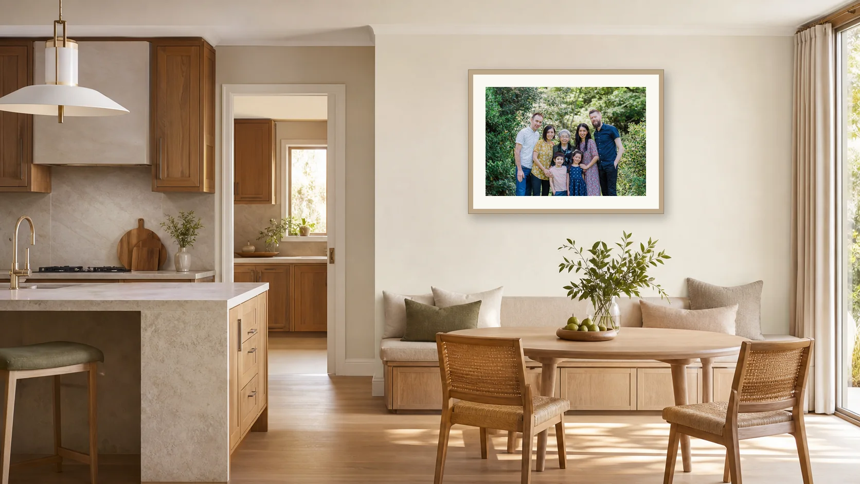 A three-generation family portrait centred on the wall above a kitchen dining banquette